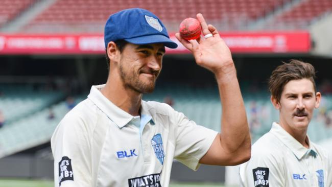 Mitchell Starc with the pink ball after taking 8-73 runs at Adelaide Oval