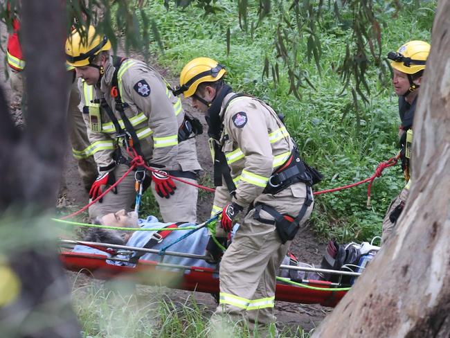 Rescue services bring a man up through the bush who was found on the banks of the Yarra in Kew. Wednesday, July 17.2024. Picture: David Crosling