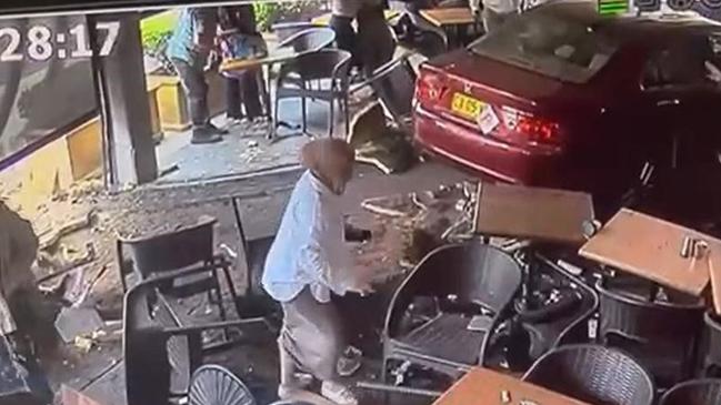 Four people injured as car ploughs into cafe