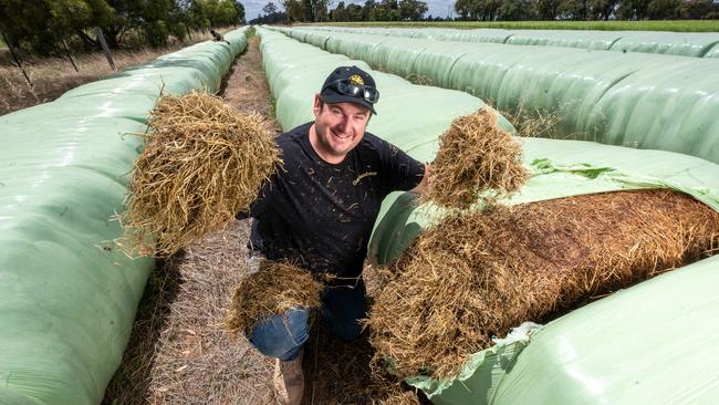 Fodder producer Tom Galloway with hay fodder on his farm at Koyuga in northern Victoria. Picture: Rob Leeson