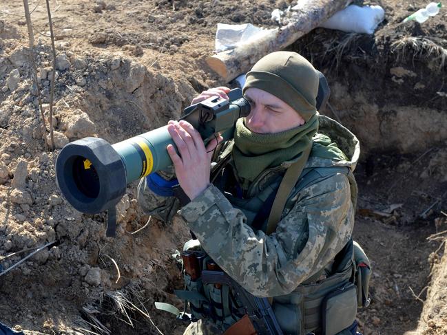 A serviceman of Ukrainian military forces holds a FGM-148 Javelin, an American-made portable anti-tank missile, at a checkpoint, where they hold a position near Kharkiv. Picture: AFP