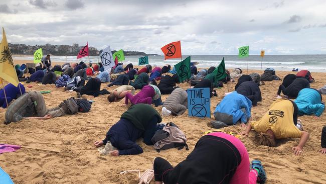 Extinction Rebellion protest at Manly, where activists put their heads in the sand. Picture: Julie Cross