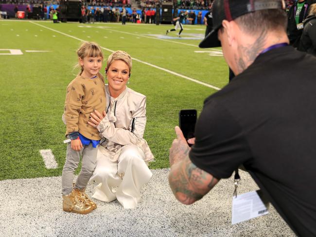 Carey Hart takes a photo of his wife Pink posing with daughter Willow Sage Hart before the National Anthem during the Super Bowl LII Pregame show at U.S. Bank Stadium on February 4, 2018 in Minneapolis, Minnesota. Picture: Getty