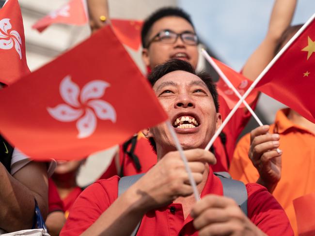 HONG KONG, HONG KONG - OCTOBER 01: People celebrate as they wave Hong Kong flags and China national flags during a flag raising ceremony as part of China's National Day celebrations on October 1, 2018 in Hong Kong, Hong Kong. Hong Kong marked the 69th anniversary of the founding of the People's Republic of China.(Photo by Anthony Kwan/Getty Images)