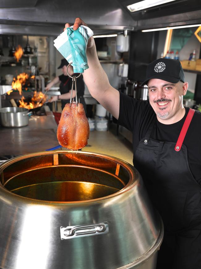 Jamie Steele tending to the duck oven. Picture Dean Martin