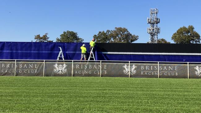 Workers on the new sight screen at Eagle Farm on Friday.