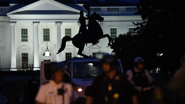 A row of police officers stand guard overnight. Picture: Eric Baradat/AFP