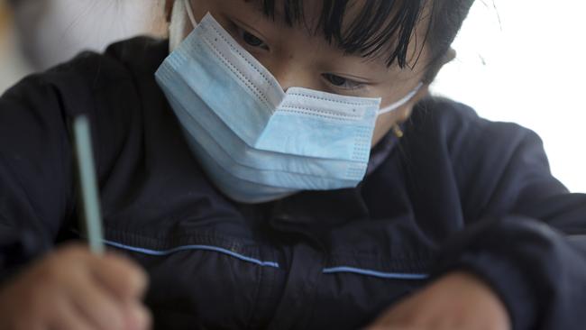 A student wears a mask as a precautionary measure at Matribhumi school in Bhaktapur, Nepal, yesterday. There has been one confirmed case of a new coronavirus infection in the Himalayan country. Picture: AP