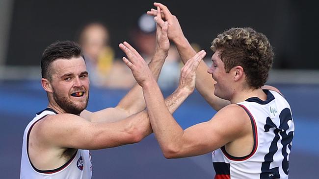 Brad Crouch congratulated by Harry Schoenberg after kicking a goal.