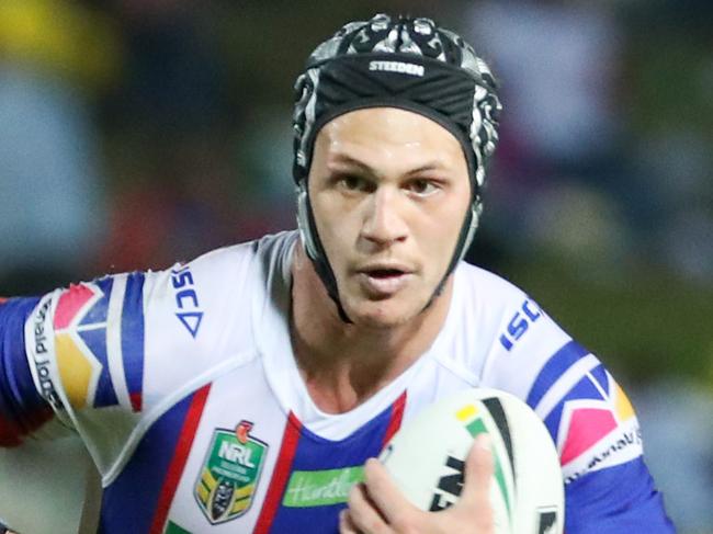 Kalyn Ponga of the Knights is tackled by Jake Clifford of the Cowboys during the Round 20 NRL match between the North Queensland Cowboys and Newcastle Knights at 1300SMILES Stadium in Townsville, Friday, July 27, 2018. (AAP Image/Michael Chambers) NO ARCHIVING, EDITORIAL USE ONLY