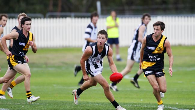 Arnold fires off a handball against Hobart back in the early days of the TSL.