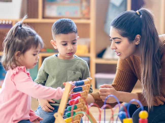 A female Kindergarten teacher of Middle Eastern decent, sits on the floor with students as they play with various toys and engage in different activities.  They are each dressed casually as they learn through their play.  Picture: istock
