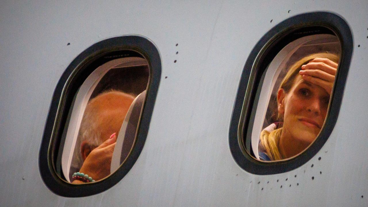 Passengers were anxious to arrive on a French government flight from Noumea at Brisbane International Airport in Brisbane on Wednesday. Picture: AFP via NewsWire