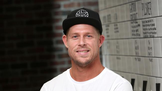 Mick Fanning celebrates with a beer at his Balter brewery at Currumbin after being awarded an AO in the Australia Day honour's list. Picture: Nigel Hallett