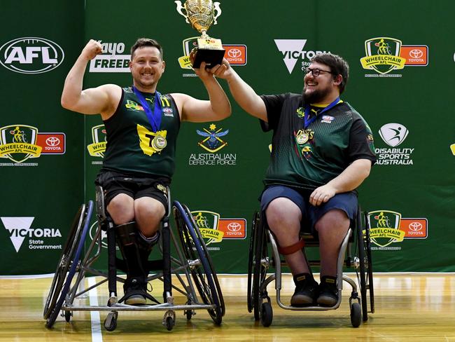 Josh Christian of Tasmania and Tasmania Head Coach Joe Chivers hold the premiership cup aloft after winning the AFL Wheelchair National Championships title last year. (Photo by Josh Chadwick/AFL Photos/via Getty Images)