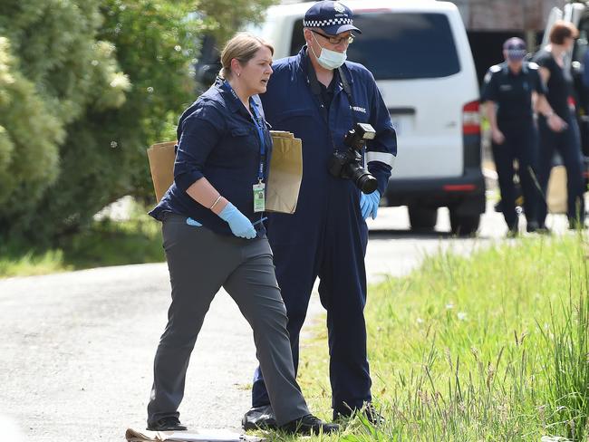 Police examine the scene. Picture: Lawrence Pinder