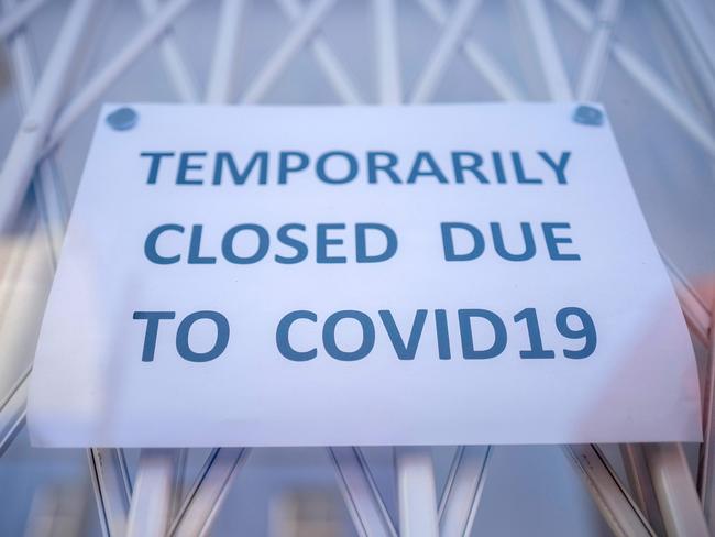 (FILES) In this file photo taken on June 01, 2020 A sign is seen in the window of a shop explaining to customers that it has temporarily closed due to the coronavirus outbreak in Portobello Market in west London, following the easing of the lockdown restrictions during the novel coronavirus pandemic. - Electoral success, Brexit, a global health crisis that left him near death, divorce, engagement and even a new baby. Boris Johnson has had an eventful 12 months in anyone's book. Johnson, 56, marks his first anniversary as Britain's prime minister on Friday, having had what one lawmaker described to the Guardian newspaper as a "hell of a year". But his toughest test could yet be to come, as the full impact of the coronavirus outbreak bites on the UK economy, which has been battered by three months of enforced shutdown. (Photo by Tolga AKMEN / AFP)