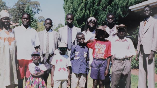 Ayik Chut with members of his family after arriving in Australia in 1996. Ayik is back row, second from right.