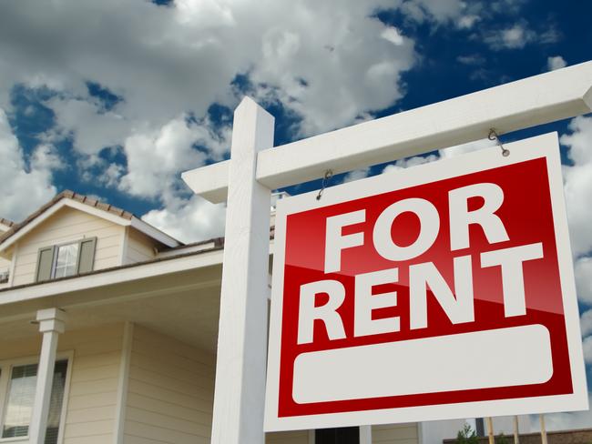 Left Facing Red For Rent Real Estate Sign in Front of Beautiful House.