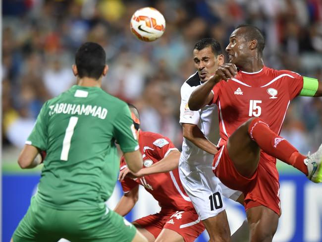 Iraq’s Younus Mahmood (No. 10) attacks the Palestine goal.