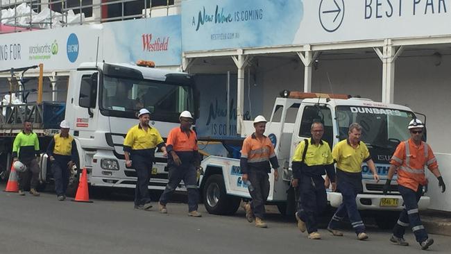 Construction workers evacuating Warringah Mall. Picture: Martin Lange