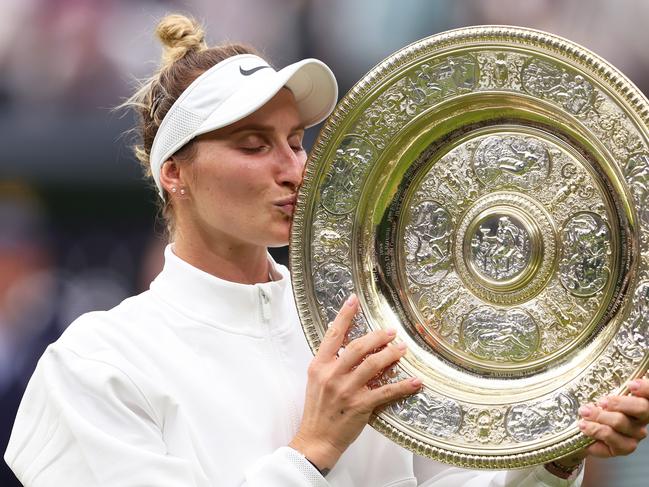 LONDON, ENGLAND - JULY 15: Marketa Vondrousova of Czech Republic kisses the Women's Singles Trophy following her victory in the Women's Singles Final against Ons Jabeur of Tunisia on day thirteen of The Championships Wimbledon 2023 at All England Lawn Tennis and Croquet Club on July 15, 2023 in London, England. (Photo by Julian Finney/Getty Images)