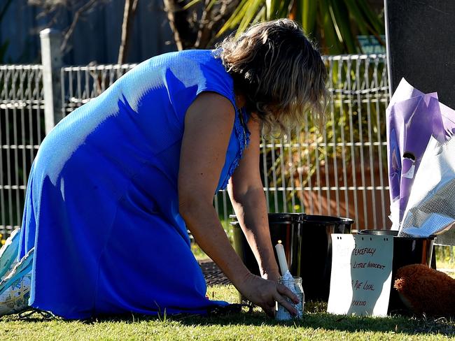 A woman leaves a tribute outside the home. Picture: Nicole Garmston