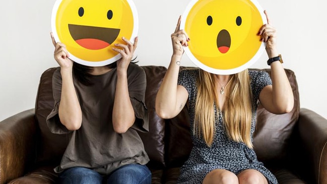 Interracial women holding an expressive emoticon face surprised and happy facial expression social media and chat concept ***These graphics are derived from our own 3D generic designs. They do not infringe on any copyright design.