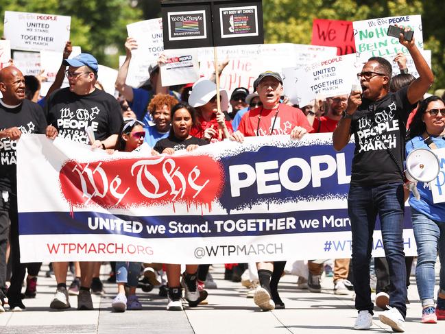 LOS ANGELES, CALIFORNIA - JULY 02: Demonstrators carry signs during the We The People March in protest of the hundreds of bills being introduced which are directed towards LGTBQ+ people, people of color and women on July 2, 2023 in Los Angeles, California. The march took place in the wake of recent conservative U.S. Supreme Court rulings and was held in solidarity with the main march held today in Fort Lauderdale, Florida. According to the American Civil Liberties Union, nearly 500 anti-LGBTQ+ bills have been introduced across the U.S. in state legislatures since the beginning of 2023.   Mario Tama/Getty Images/AFP (Photo by MARIO TAMA / GETTY IMAGES NORTH AMERICA / Getty Images via AFP)