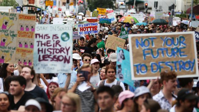 School student activists march down George Street, Brisbane to Queensland State Parliament to protest about political inaction on climate change. Picture AAP Image/Claudia Baxter