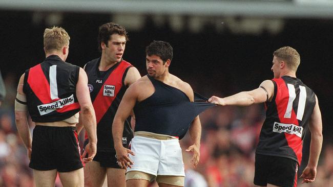 Mark Johnson, Dean Solomon and Damien Hardwick set upon Demon Jeff Farmer in the 2020 grand final.