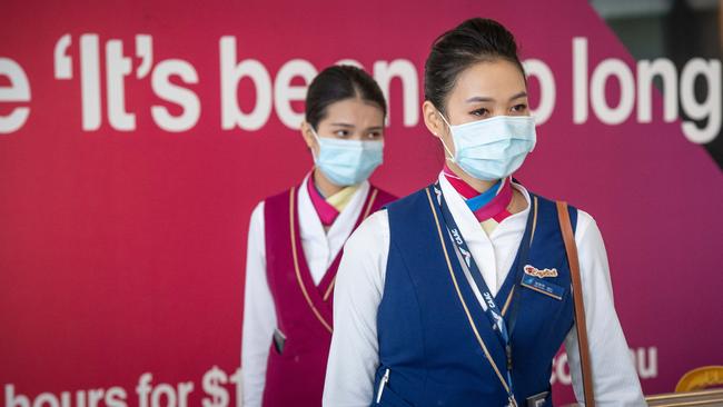 Passengers and crew arriving in Adelaide on the China Southern Airlines flight from Guangzhou wearing facemarks to protect themselves from coronavirus. Picture: Brad Fleet