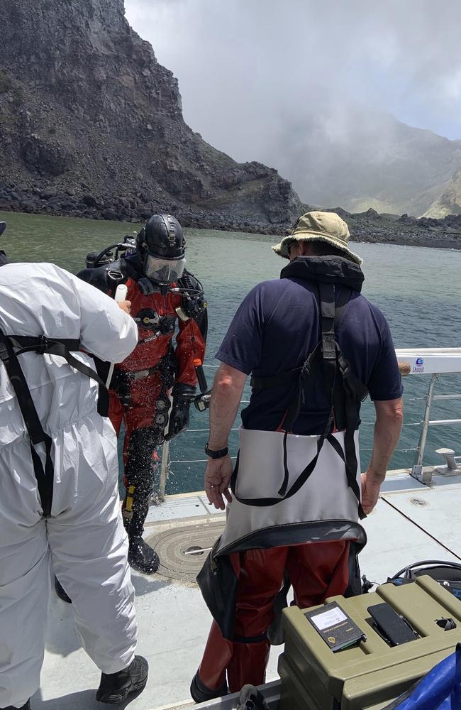 Police divers prepare to search the waters near White Island off the coast of Whakatane, New Zealand.