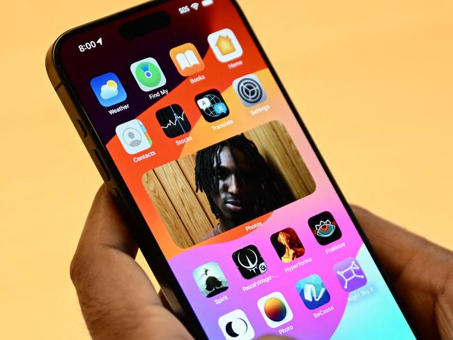 A customer holds an Apple iPhone 15 series device displayed for sale at The Grove Apple retail store on release day in Los Angeles, California, on September 22, 2023. (Photo by Patrick T. Fallon / AFP)