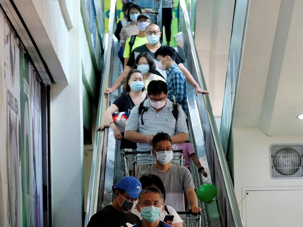 Under new level three restrictions, shoppers must wear face masks when outside their homes. Picture: Sam Yeh/AFP