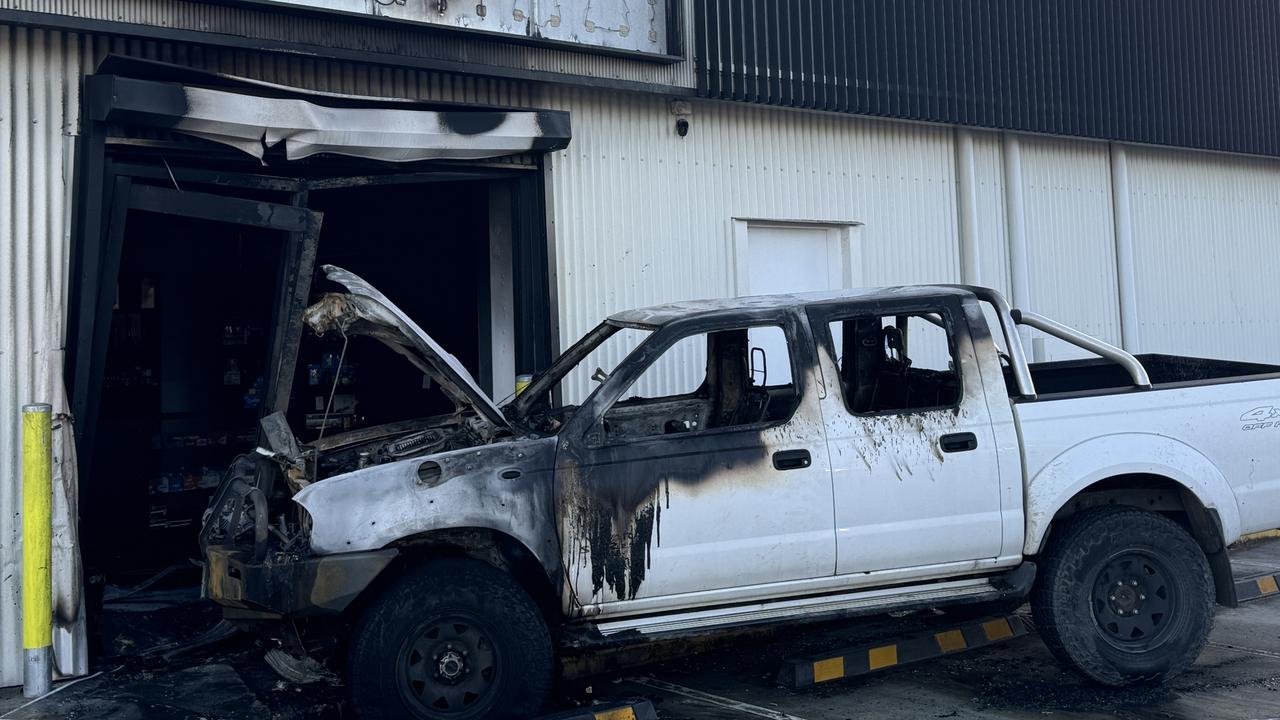 A burnt out ute at the front of a Strathpine tobacconist which was rammed on Wednesday night.