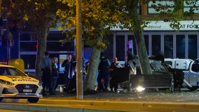 Police at the scene of an overturned car in Newcastle. Picture: Dan Irwin