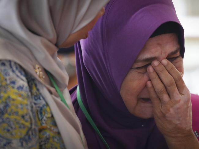 Sarah Nor, the mother of Norliakmar Hamid, a passenger on missing Malaysia Airlines flight MH370, cries after she attended a briefing on the final investigation report. Picture: AP