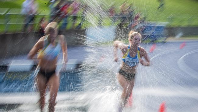 Steeplechase water jump action as Allegra McGivern from Tamarama races to victory.