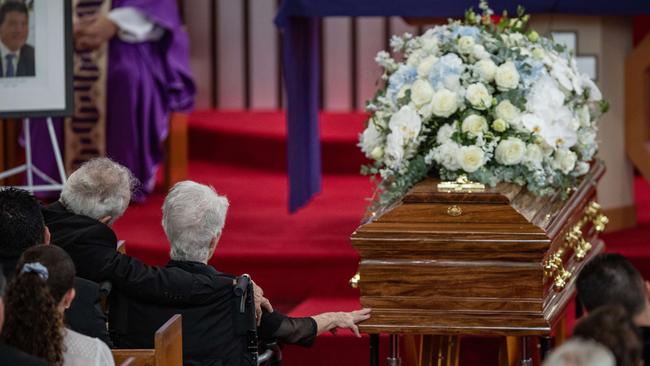 Tony Plati’s mother, Maria, reaches out to lovingly touch his casket. Picture: Julian Andrews