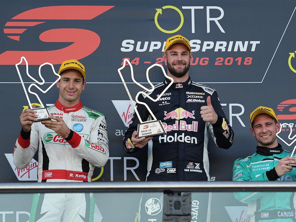 Runner up Rick Kelly from Nissan Motorsport, winner Shane Van Gisbergen from Red Bull Holden Racing Team and third placed Michael Caruso from Nissan Motorsport celebrate on the podium. Photo by Daniel Kalisz/Getty Images