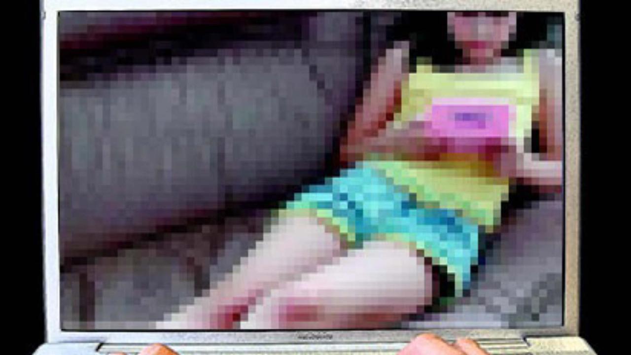 child porn - generic of hands on computer laptop keybord with a photograph of a young child on the screen re: Child sex exploitation. Picture: Supplied