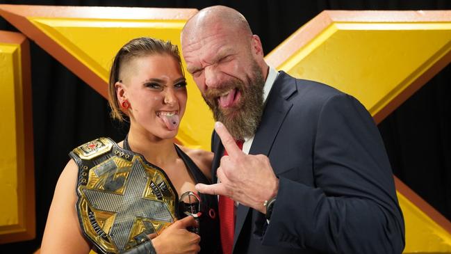 Adelaide-born wrestler Rhea Ripley, celebrating her NXT Women's Championship win, with WWE boss Triple H. Picture: WWE