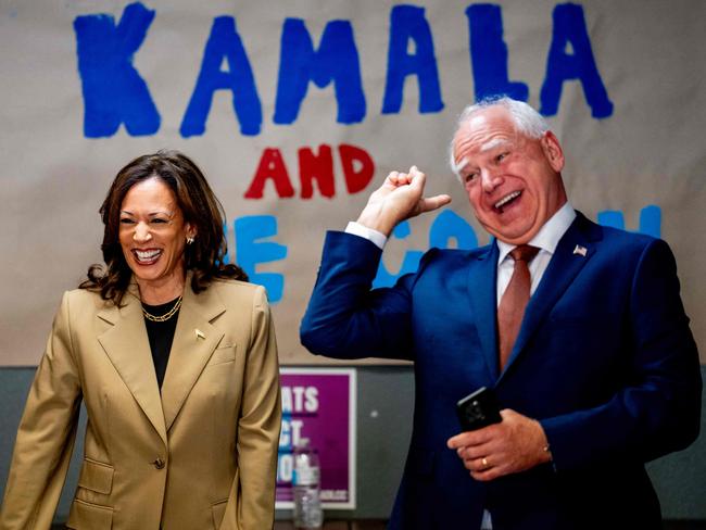 GLENDALE, ARIZONA - AUGUST 9: Democratic presidential candidate, U.S. Vice President Kamala Harris and Democratic vice presidential candidate Minnesota Gov. Tim Walz laugh after taking a selfie in front of a sign that reads "Kamala and The Coach" during stop at a campaign office on August 9, 2024 in Glendale, Arizona. Kamala Harris and her newly selected running mate Tim Walz are campaigning across the country this week.   Andrew Harnik/Getty Images/AFP (Photo by Andrew Harnik / GETTY IMAGES NORTH AMERICA / Getty Images via AFP)