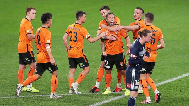 The Roar’s Scott McDonald celebrates with teammates after scoring against Melbourne Victory. Picture: Matt King/Getty Images