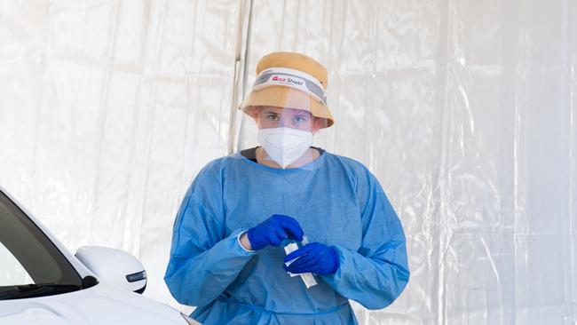 A health worker is seen at a drive through Covid-19 clinic. Picture: NCA NewsWire / Dan Peled