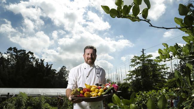 Chef Glen Barratt in the gardens of Wild Canary (in 2017) holding some of the unusual produce. Picture: Mark Cranitch