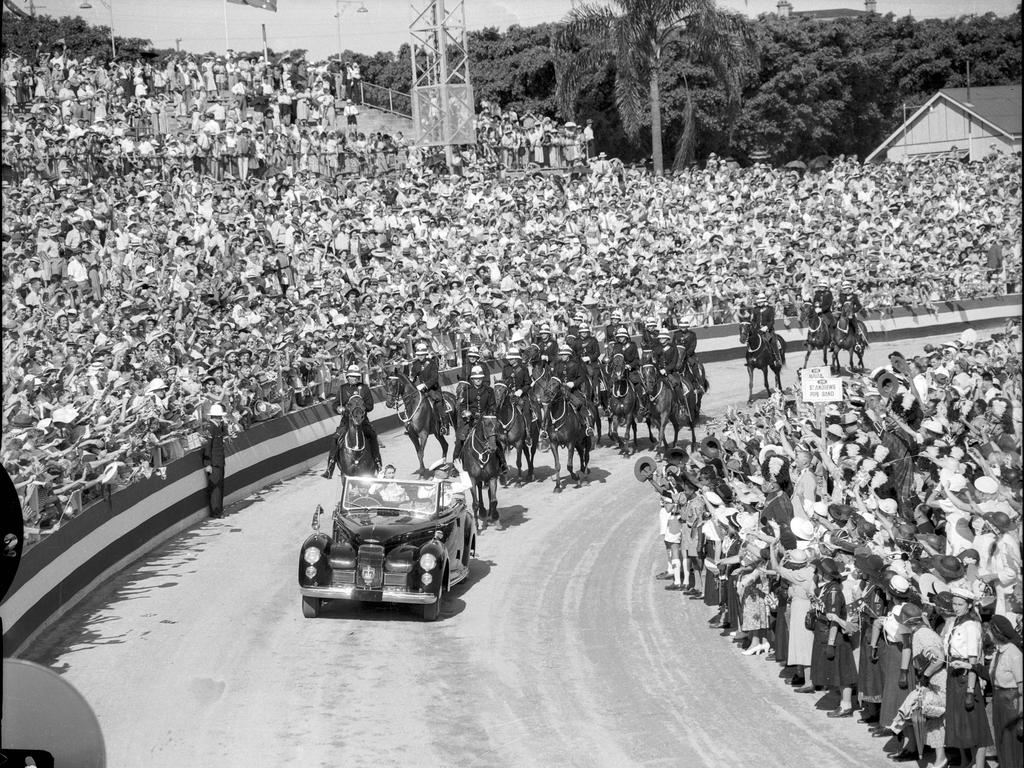 Queen Elizabeth II and Duke of Edinburgh Prince Phillip with a mounted police escort during the civic welcome at the Exhibition Grounds in Brisbane in 1954.