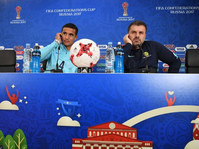 Australia's forward Tim Cahill (L) and Australia's coach Ange Postecoglou