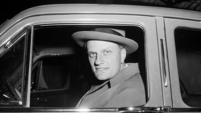 Billy Graham pictured in his car, 1955. Picture: Getty Images.